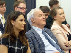 The audience listens attentively