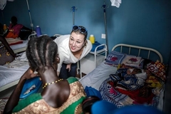 Jutta Urpilainen greets a woman while visiting the maternity area at a Hospital funded by EU in Kakuma.